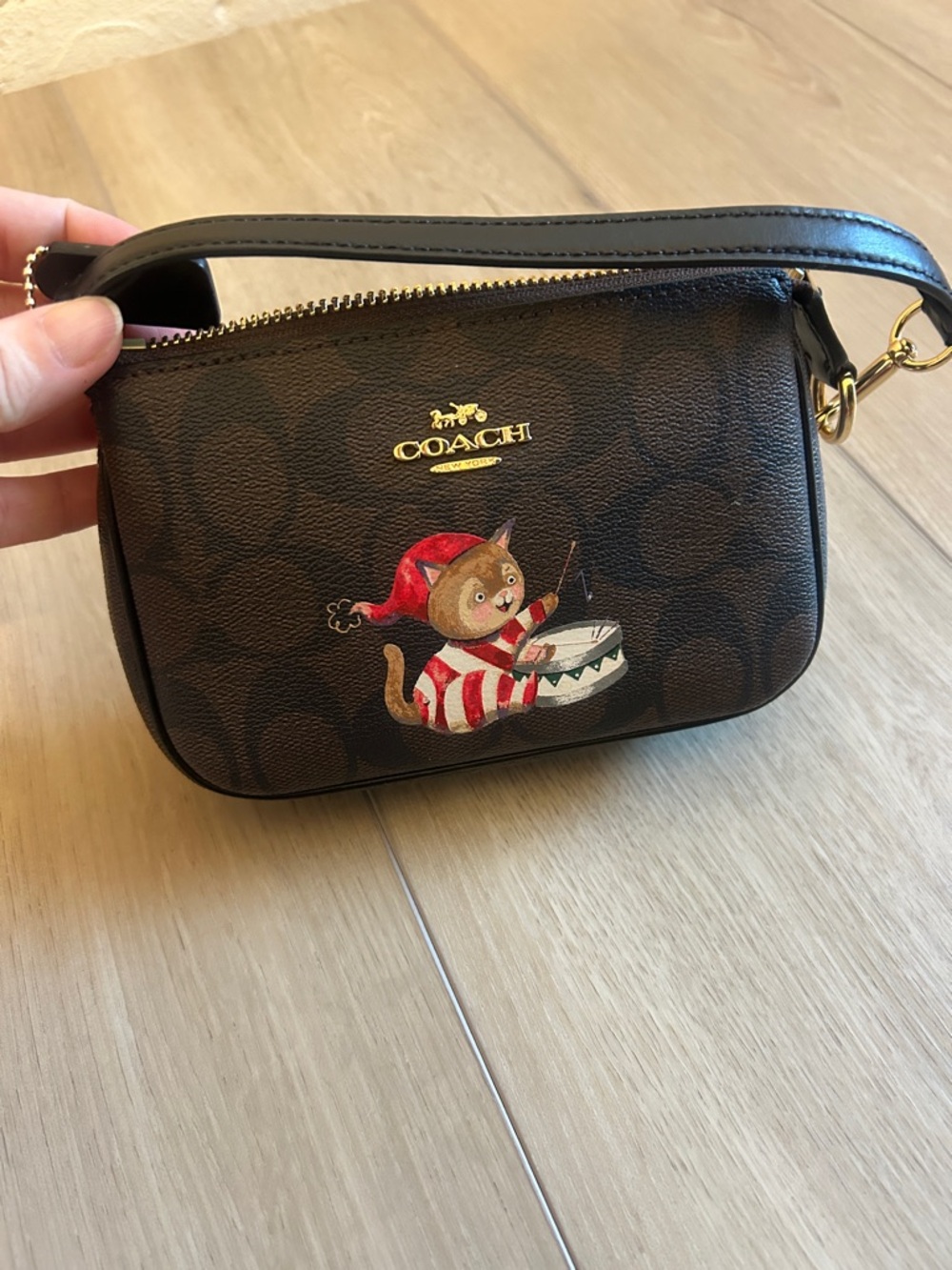 Coach Brown Signature Wristlet with Festive Cat Drummer Graphic